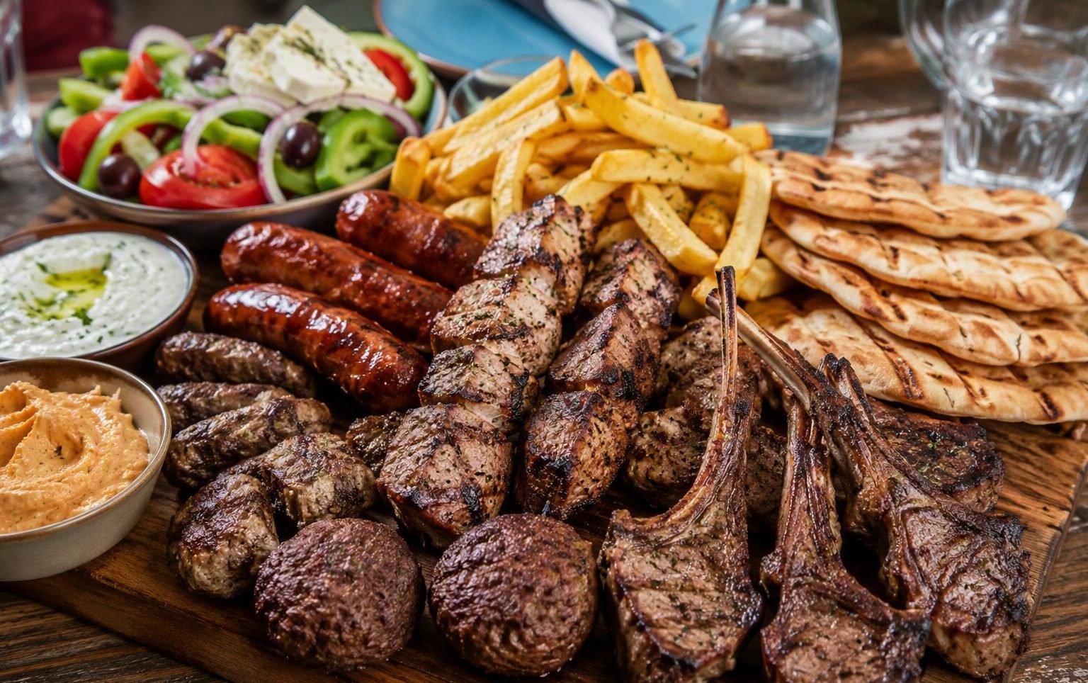 Mix grill platter: kontosouvli, lamb chops, sausages, fries and pita